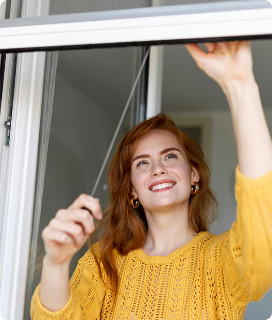 Woman installing blinds